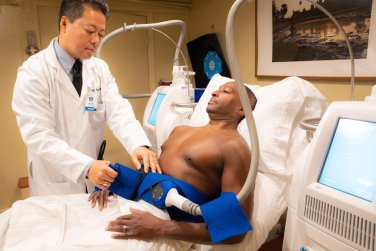 doctor preparing CoolSculpting on patient's waist.