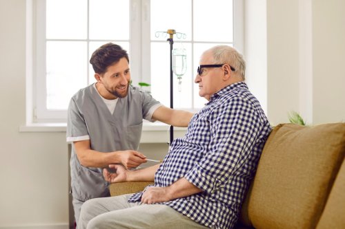 provider assisting man receiving IV.