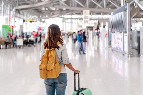 woman at airport with luggage.