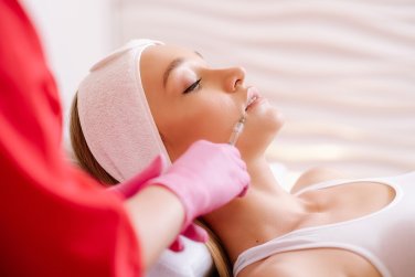 provider injecting dermal filler into face.