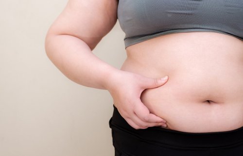 woman pinching large midsection.