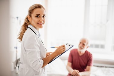 doctor with clipboard interviews a patient.