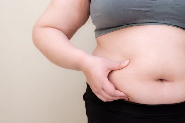 woman pinching large midsection.
